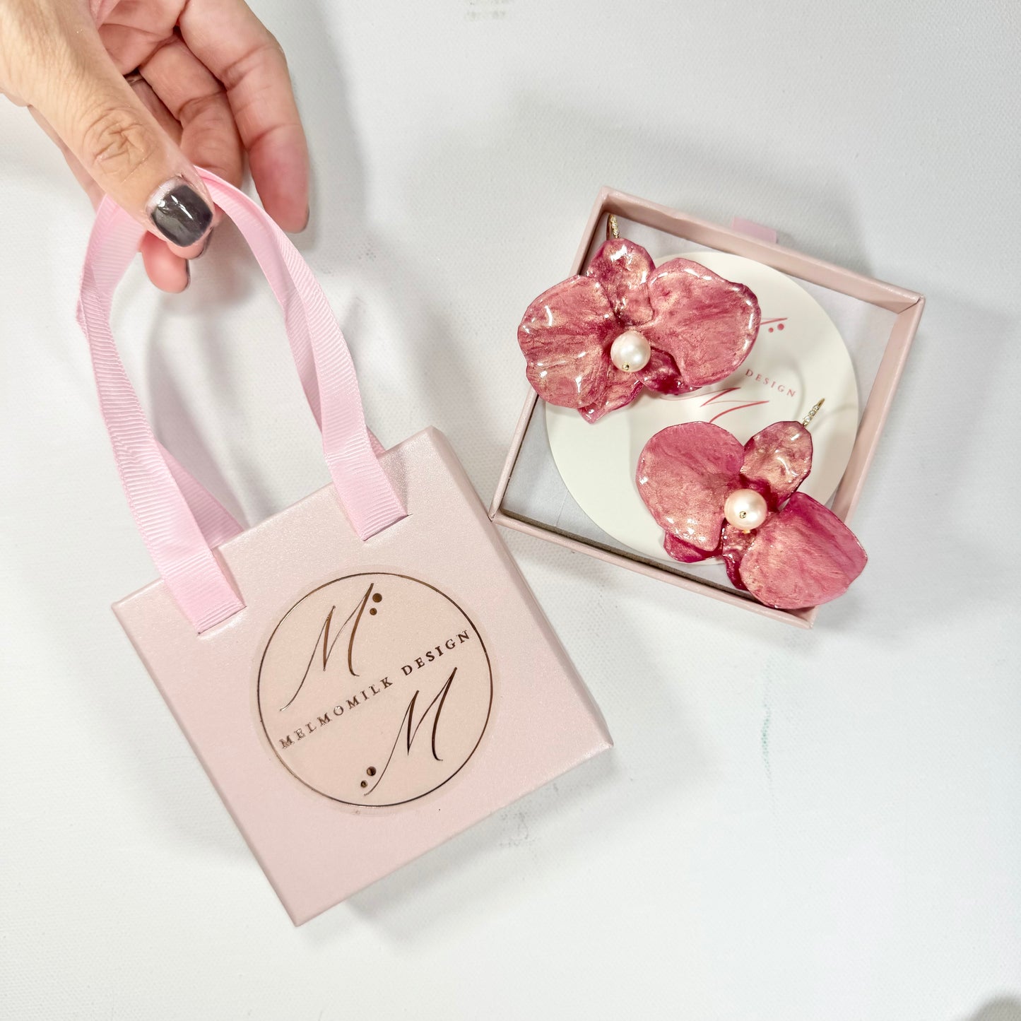Handmade upcycled orchid earrings crafted from recycled PET bottles, eco-friendly floral jewelry by a Singapore artisan, lightweight and elegant design.