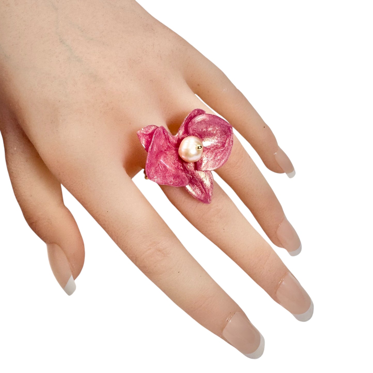 Handcrafted orchid flower ring in soft powder pink, made from upcycled materials with a velvet-like finish.