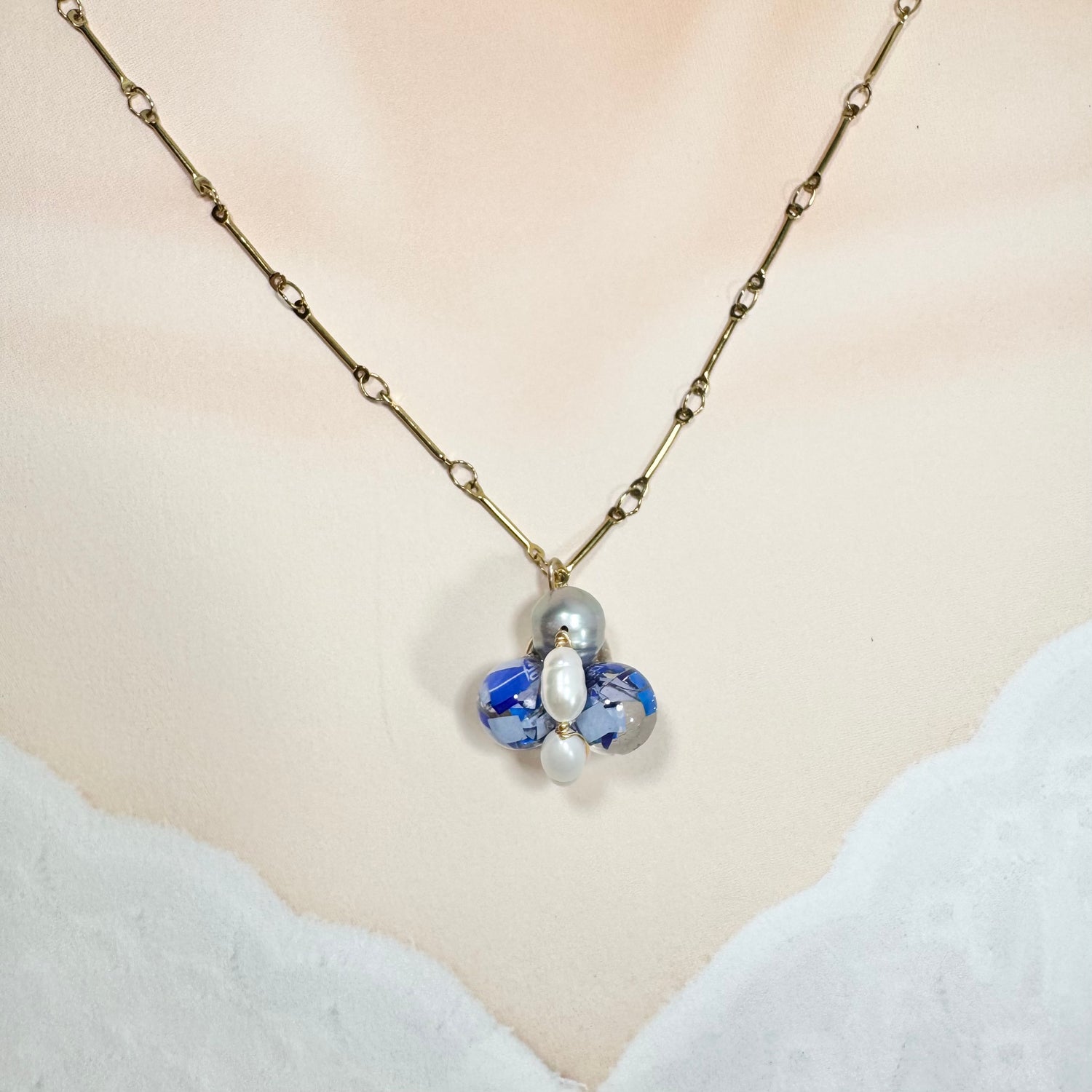 Bee Divine blue bee necklace with fresh water pearls handcrafted from upcycled plastic, featuring delicate bee-inspired designs with lightweight, eco-friendly materials. A sustainable statement piece for nature lovers.