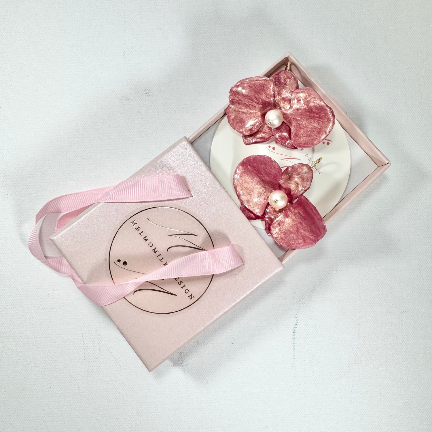 Handmade upcycled orchid earrings crafted from recycled PET bottles, eco-friendly floral jewelry by a Singapore artisan, lightweight and elegant design.