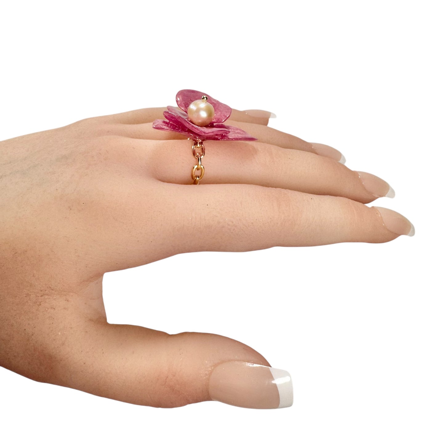 Handcrafted orchid flower ring in soft powder pink, made from upcycled materials with a velvet-like finish.