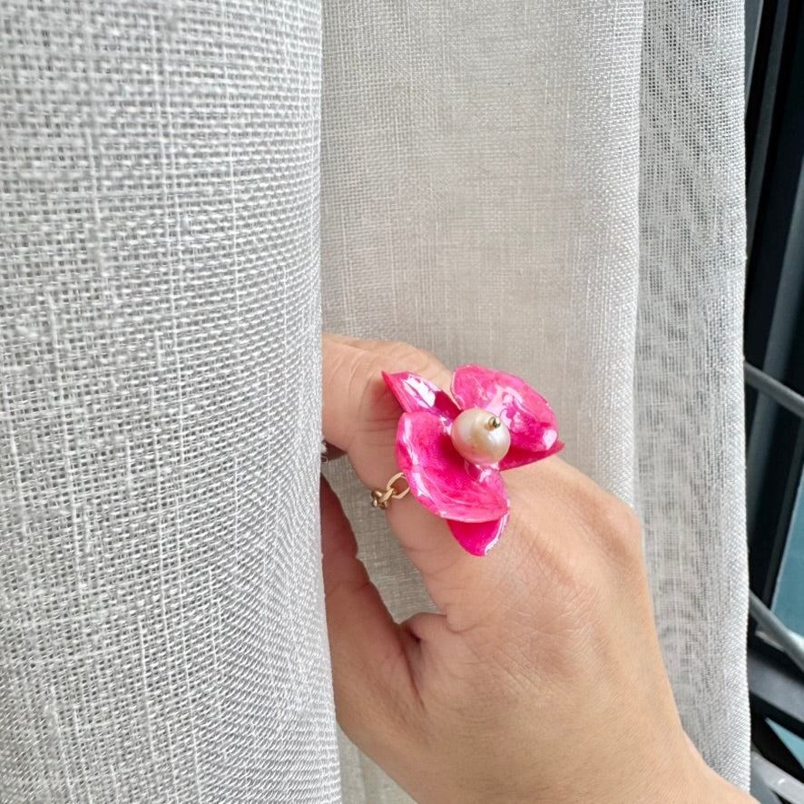 Statement flower ring inspired by orchid petals in rich red, sustainably handcrafted from upcycled materials.
