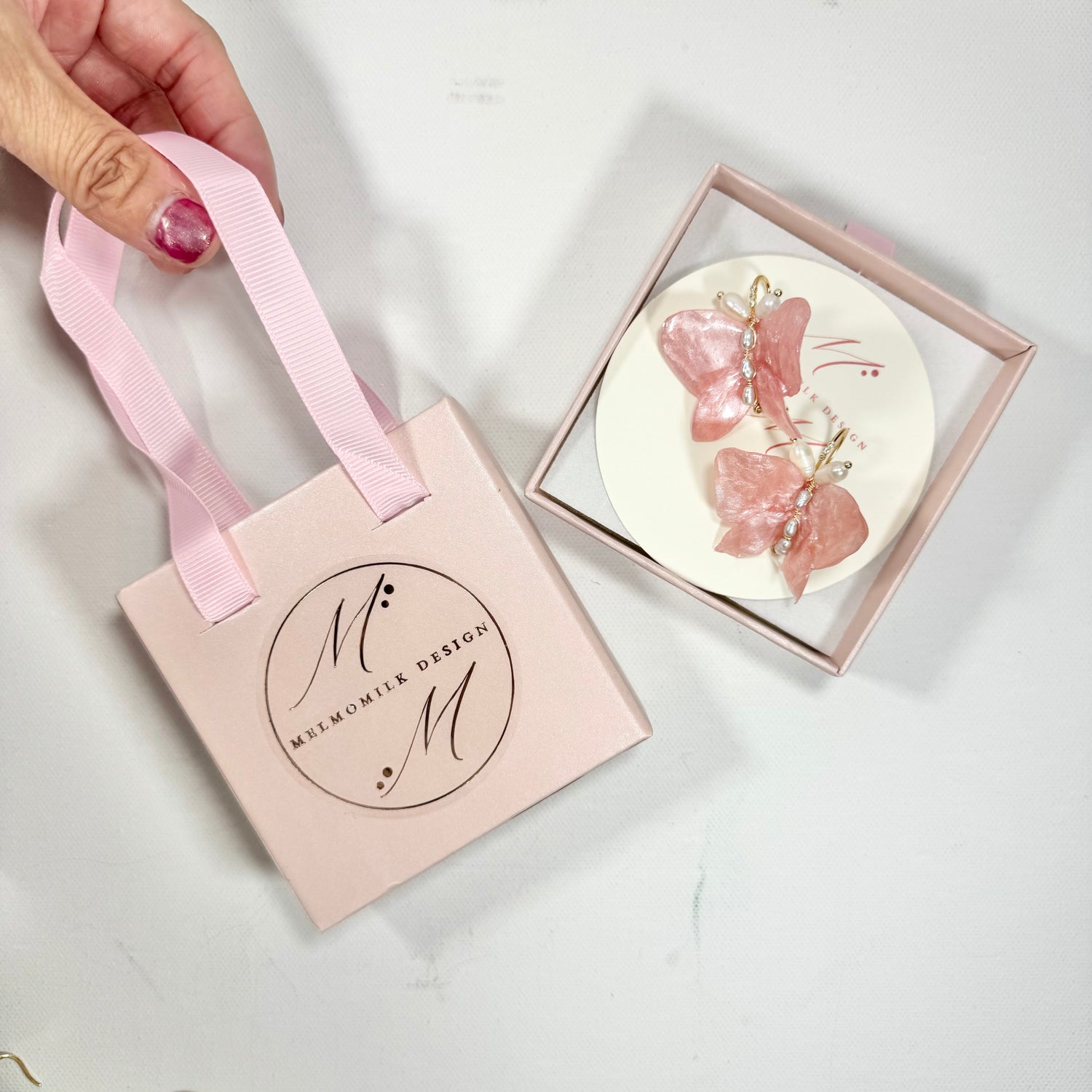 Soft pink butterfly earrings made from upcycled materials, featuring a romantic Pink Chiffon finish and delicate handmade detailing.