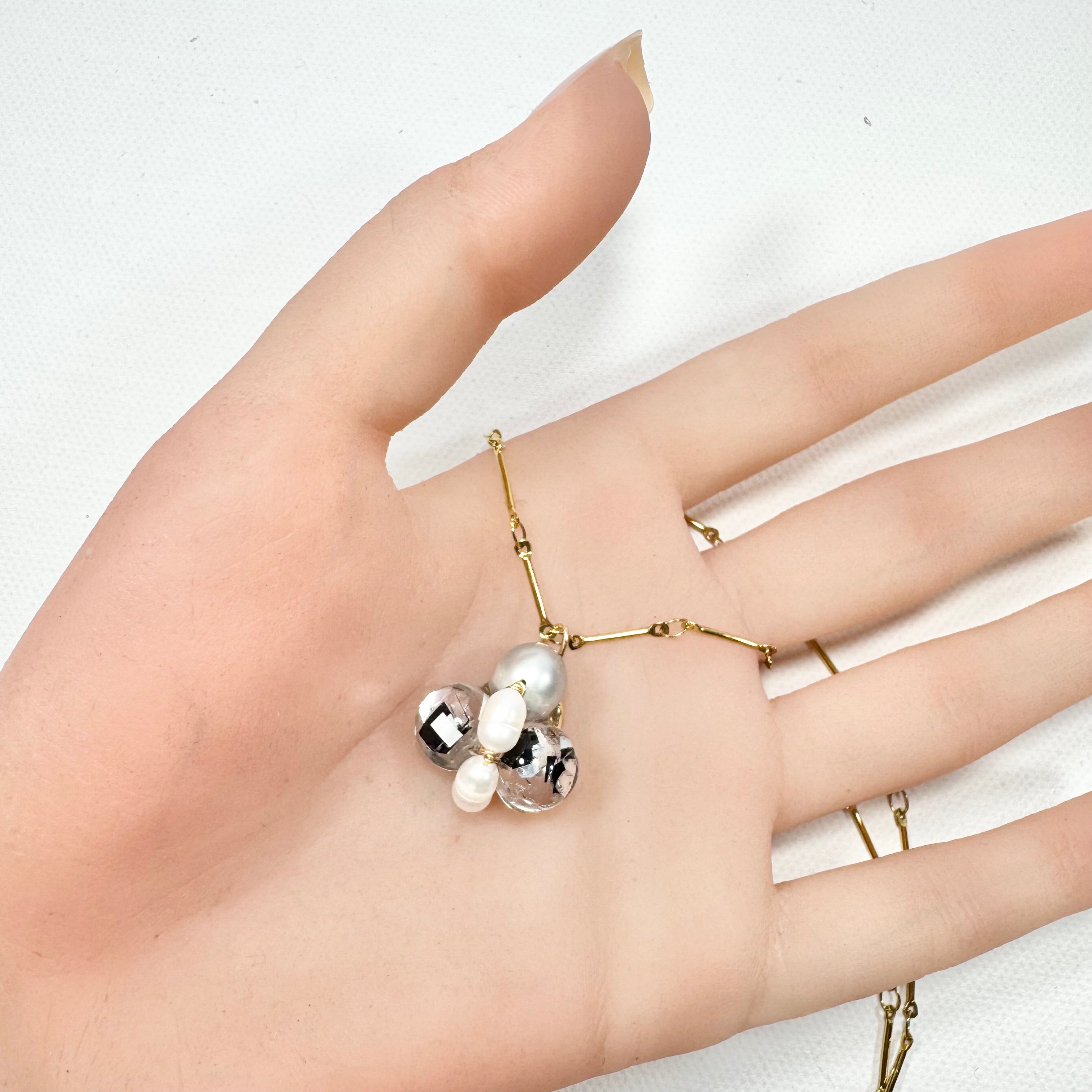 Bee Divine midnight black bee necklace with fresh water pearls handcrafted from upcycled plastic, featuring delicate bee-inspired designs with lightweight, eco-friendly materials. A sustainable statement piece for nature lovers.