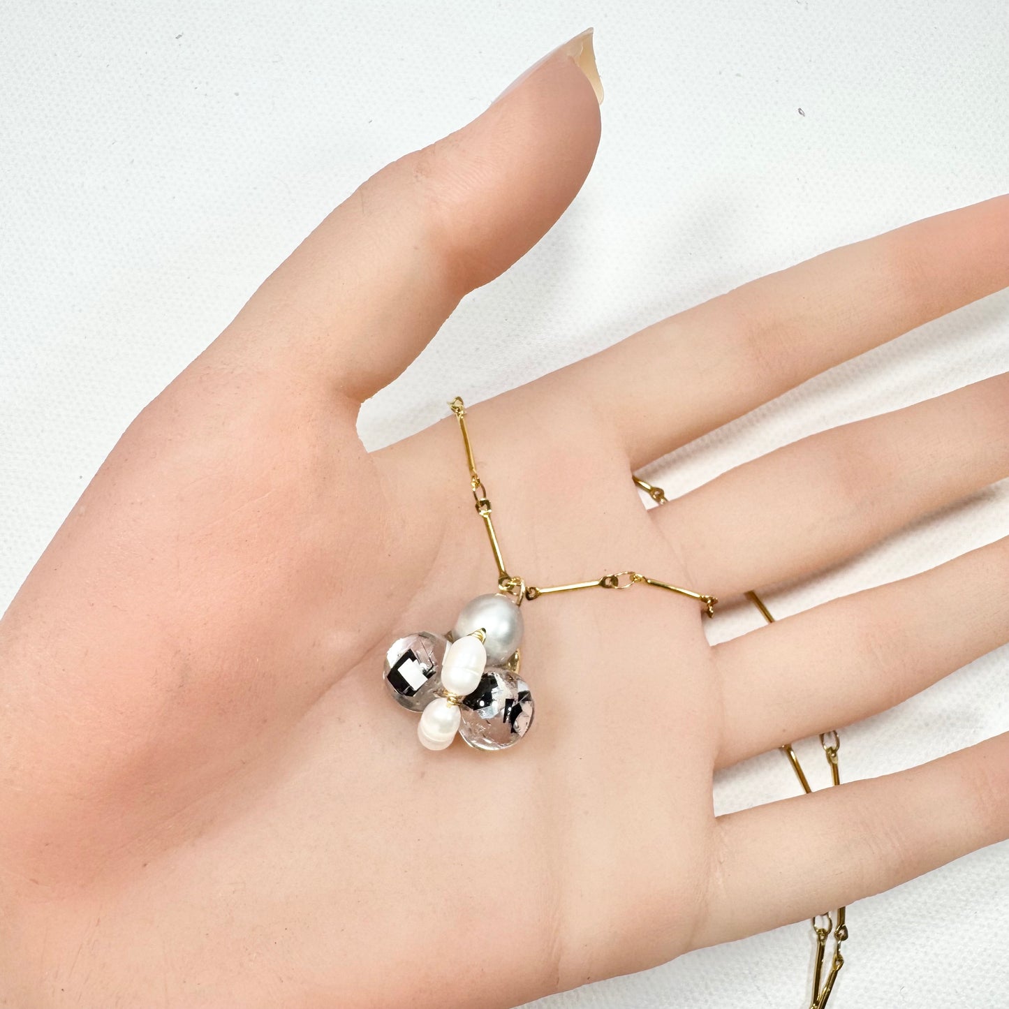 Bee Divine midnight black bee necklace with fresh water pearls handcrafted from upcycled plastic, featuring delicate bee-inspired designs with lightweight, eco-friendly materials. A sustainable statement piece for nature lovers.