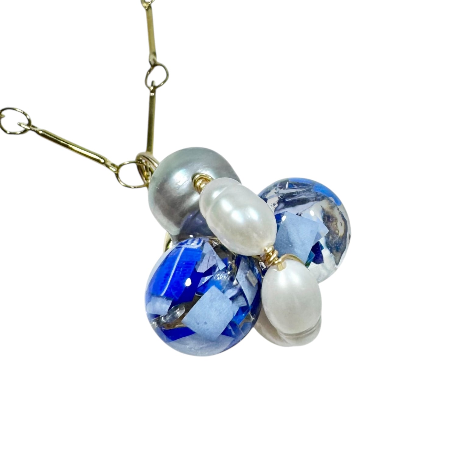 Bee Divine blue bee necklace with fresh water pearls handcrafted from upcycled plastic, featuring delicate bee-inspired designs with lightweight, eco-friendly materials. A sustainable statement piece for nature lovers.