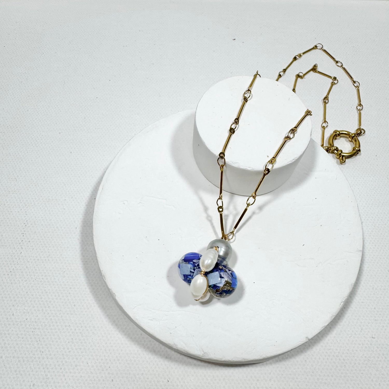 Bee Divine blue bee necklace with fresh water pearls handcrafted from upcycled plastic, featuring delicate bee-inspired designs with lightweight, eco-friendly materials. A sustainable statement piece for nature lovers.