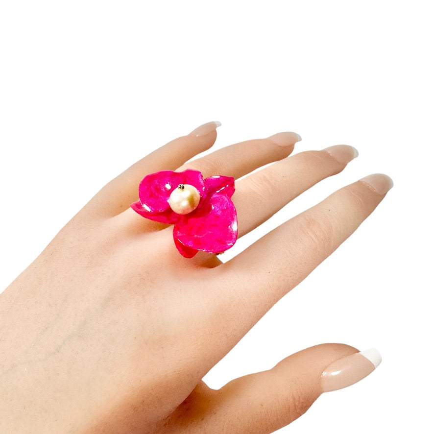 Statement flower ring inspired by orchid petals in rich red, sustainably handcrafted from upcycled materials.