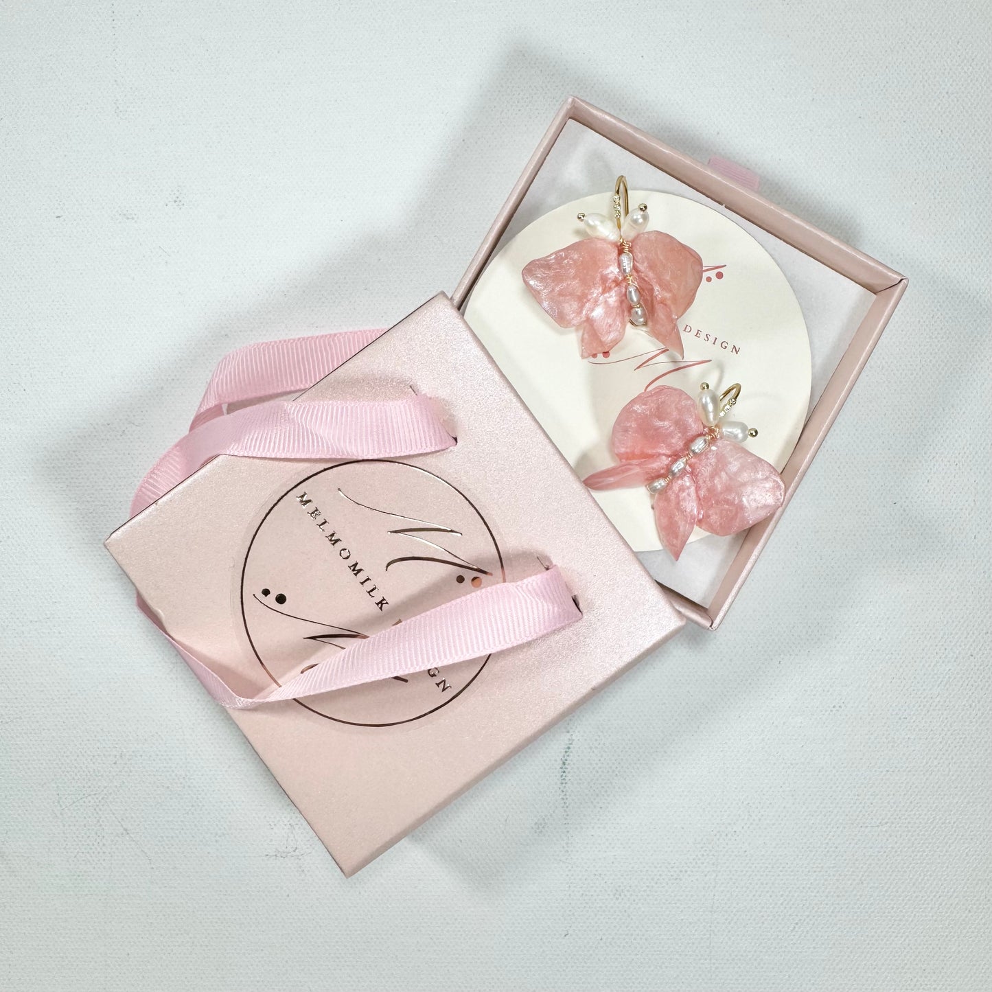 Soft pink butterfly earrings made from upcycled materials, featuring a romantic Pink Chiffon finish and delicate handmade detailing.