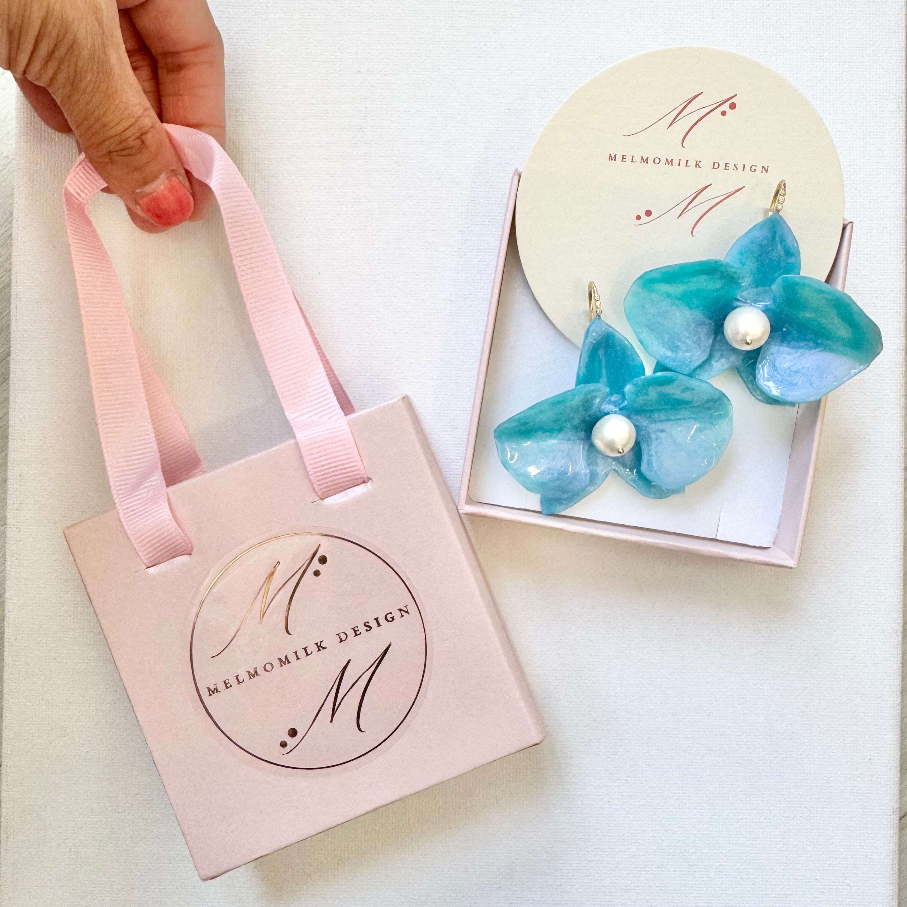 Handmade upcycled orchid earrings crafted from recycled PET bottles, eco-friendly floral jewelry by a Singapore artisan, lightweight and elegant design.