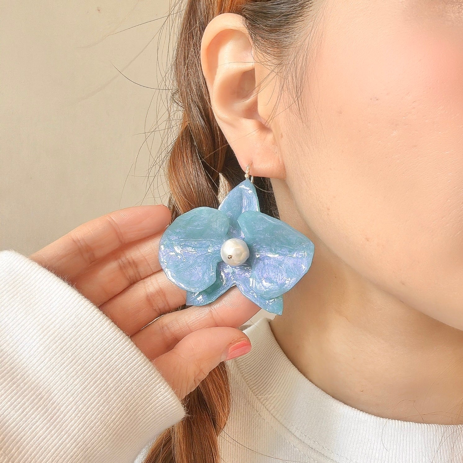 Handmade upcycled orchid earrings crafted from recycled PET bottles, eco-friendly floral jewelry by a Singapore artisan, lightweight and elegant design.