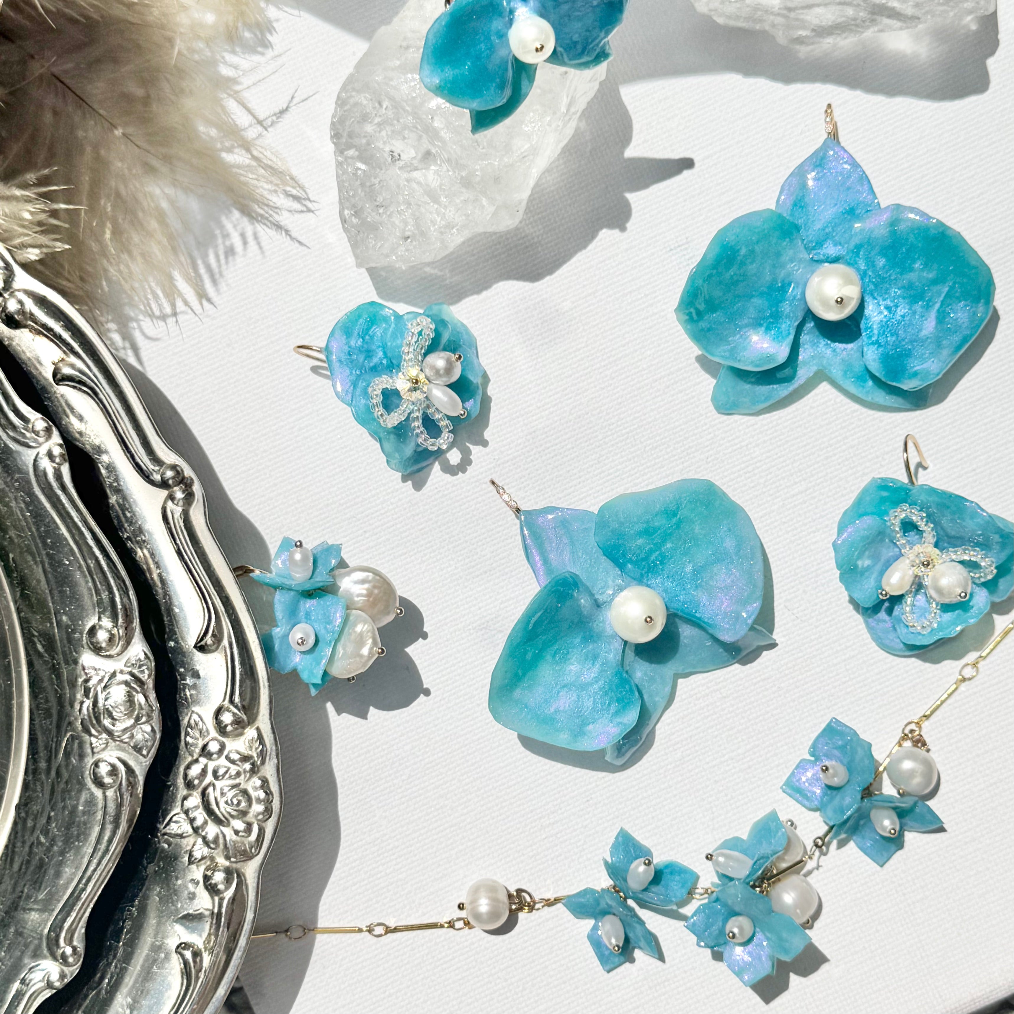 Handmade upcycled orchid earrings crafted from recycled PET bottles, eco-friendly floral jewelry by a Singapore artisan, lightweight and elegant design.