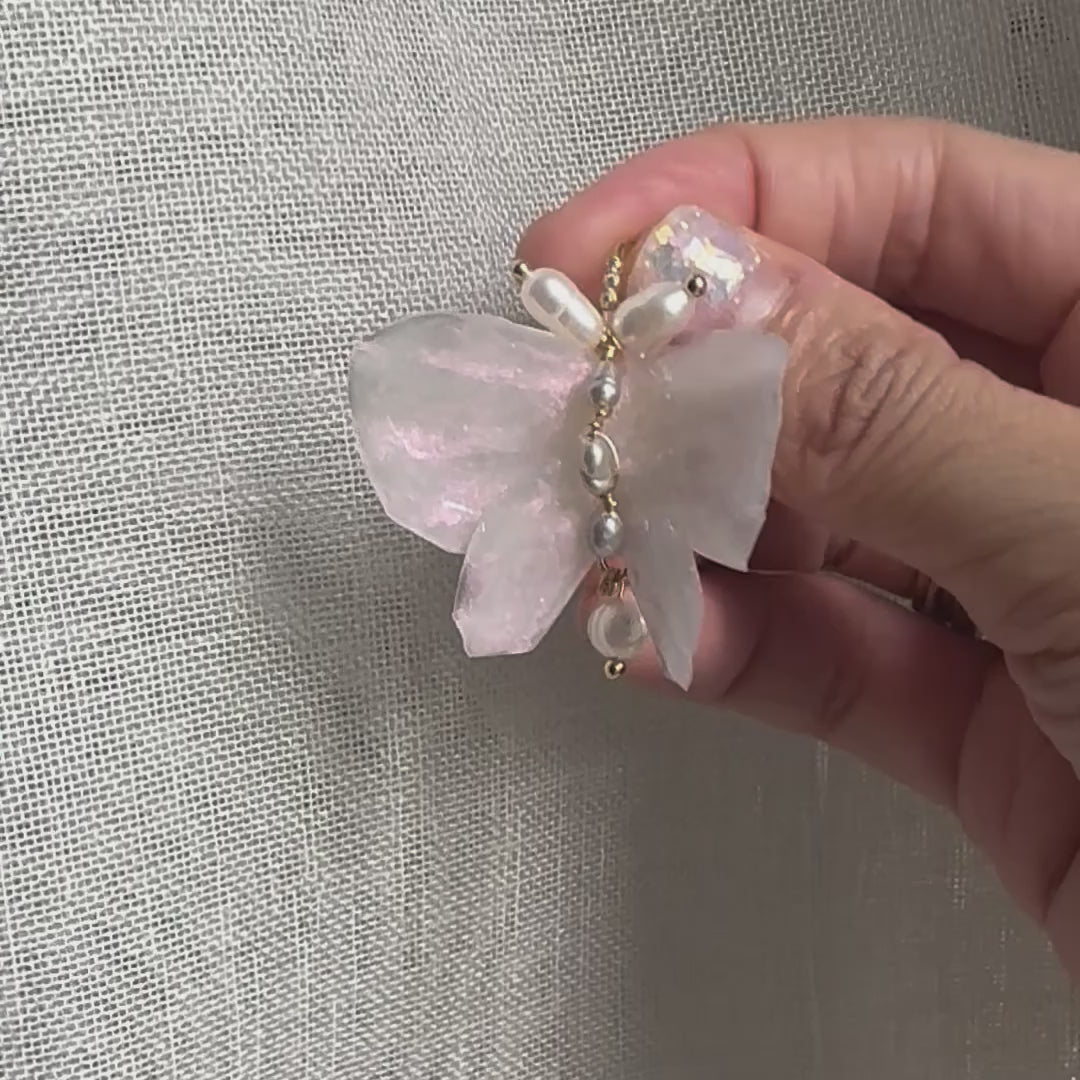Handcrafted butterfly-shaped earrings in pearl white, made from upcycled materials and finished in a luminous White Silk tone.