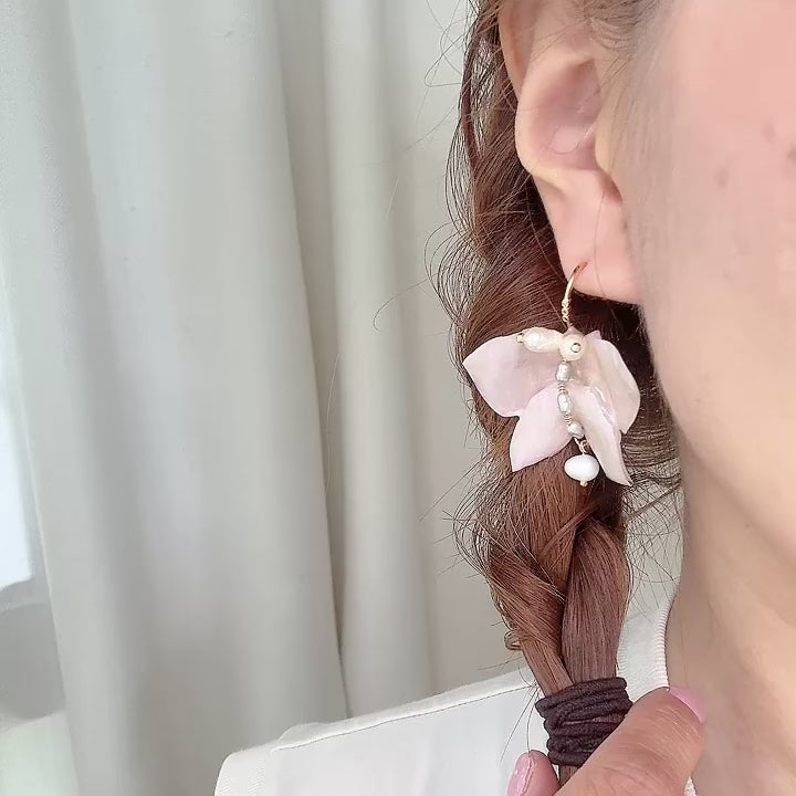 Handcrafted butterfly-shaped earrings in pearl white, made from upcycled materials and finished in a luminous White Silk tone.