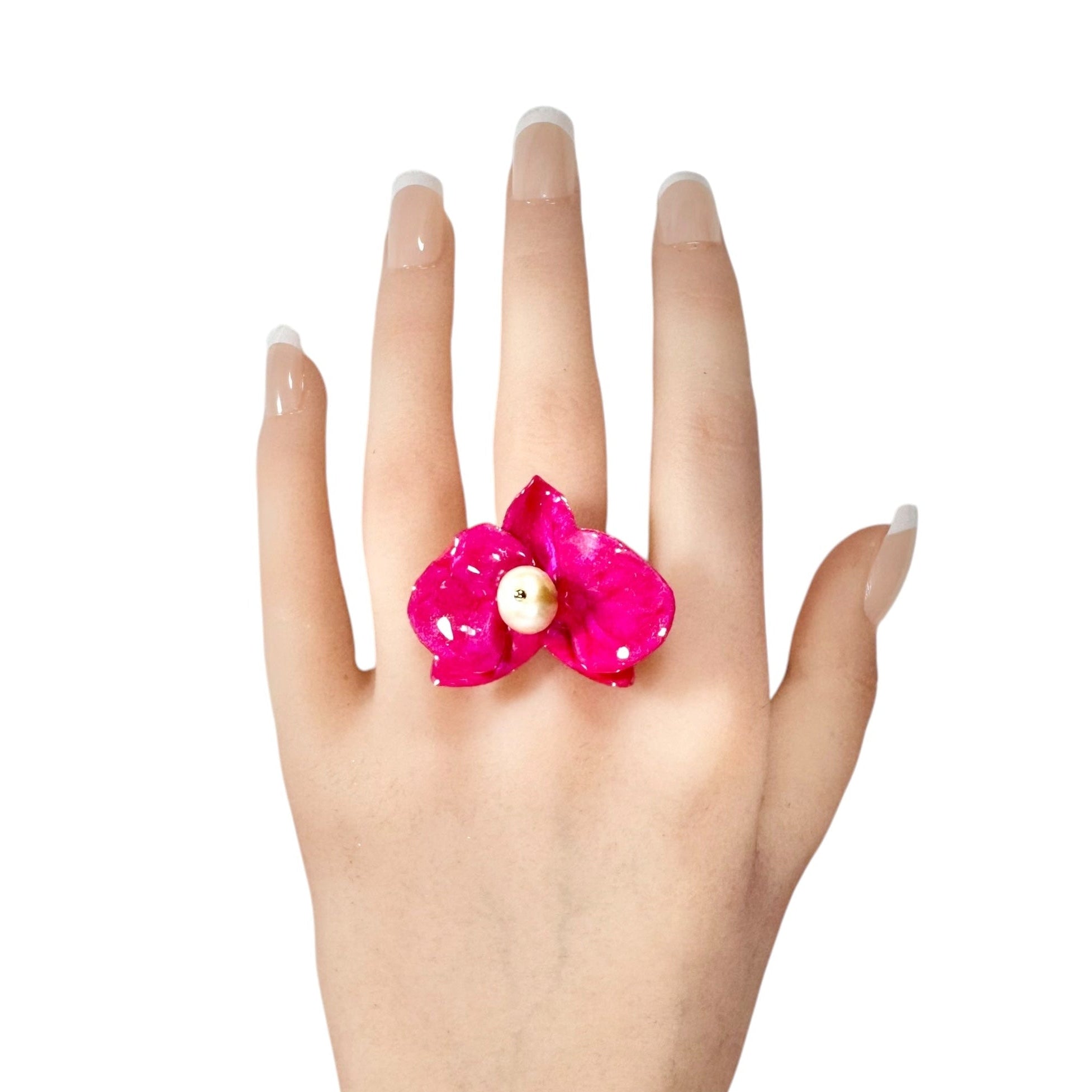 Statement flower ring inspired by orchid petals in rich red, sustainably handcrafted from upcycled materials.
