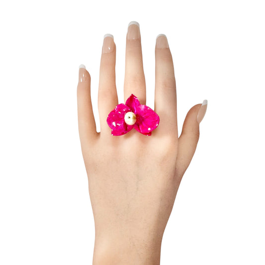 Statement flower ring inspired by orchid petals in rich red, sustainably handcrafted from upcycled materials.

