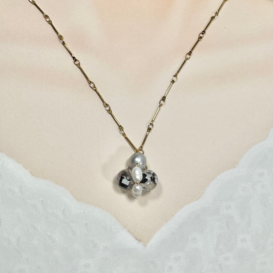 Bee Divine midnight black bee necklace with fresh water pearls handcrafted from upcycled plastic, featuring delicate bee-inspired designs with lightweight, eco-friendly materials. A sustainable statement piece for nature lovers.