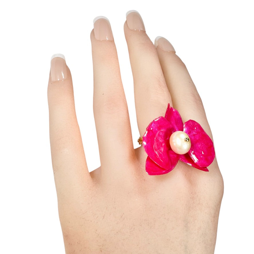 Statement flower ring inspired by orchid petals in rich red, sustainably handcrafted from upcycled materials.
