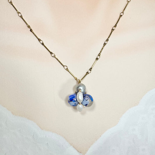 Bee Divine blue bee necklace with fresh water pearls handcrafted from upcycled plastic, featuring delicate bee-inspired designs with lightweight, eco-friendly materials. A sustainable statement piece for nature lovers.