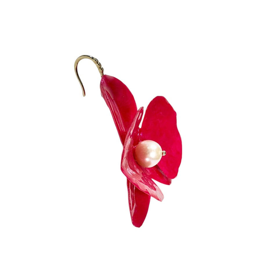 Handcrafted orchid-shaped earrings made from upcycled materials in rich red tones, symbolizing passion and elegance.
