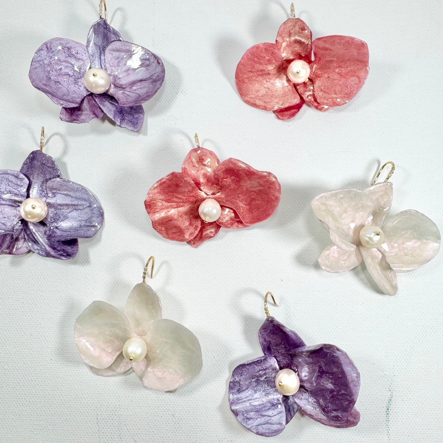 Handmade upcycled orchid earrings crafted from recycled PET bottles, eco-friendly floral jewelry by a Singapore artisan, lightweight and elegant design.