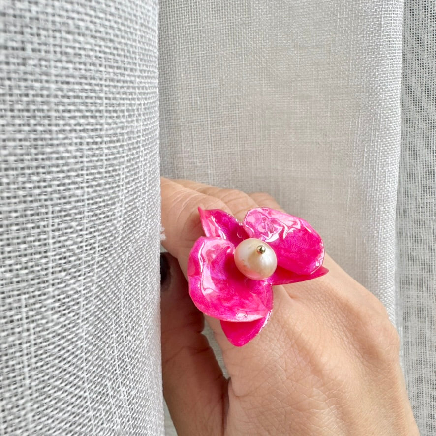 Statement flower ring inspired by orchid petals in rich red, sustainably handcrafted from upcycled materials.
