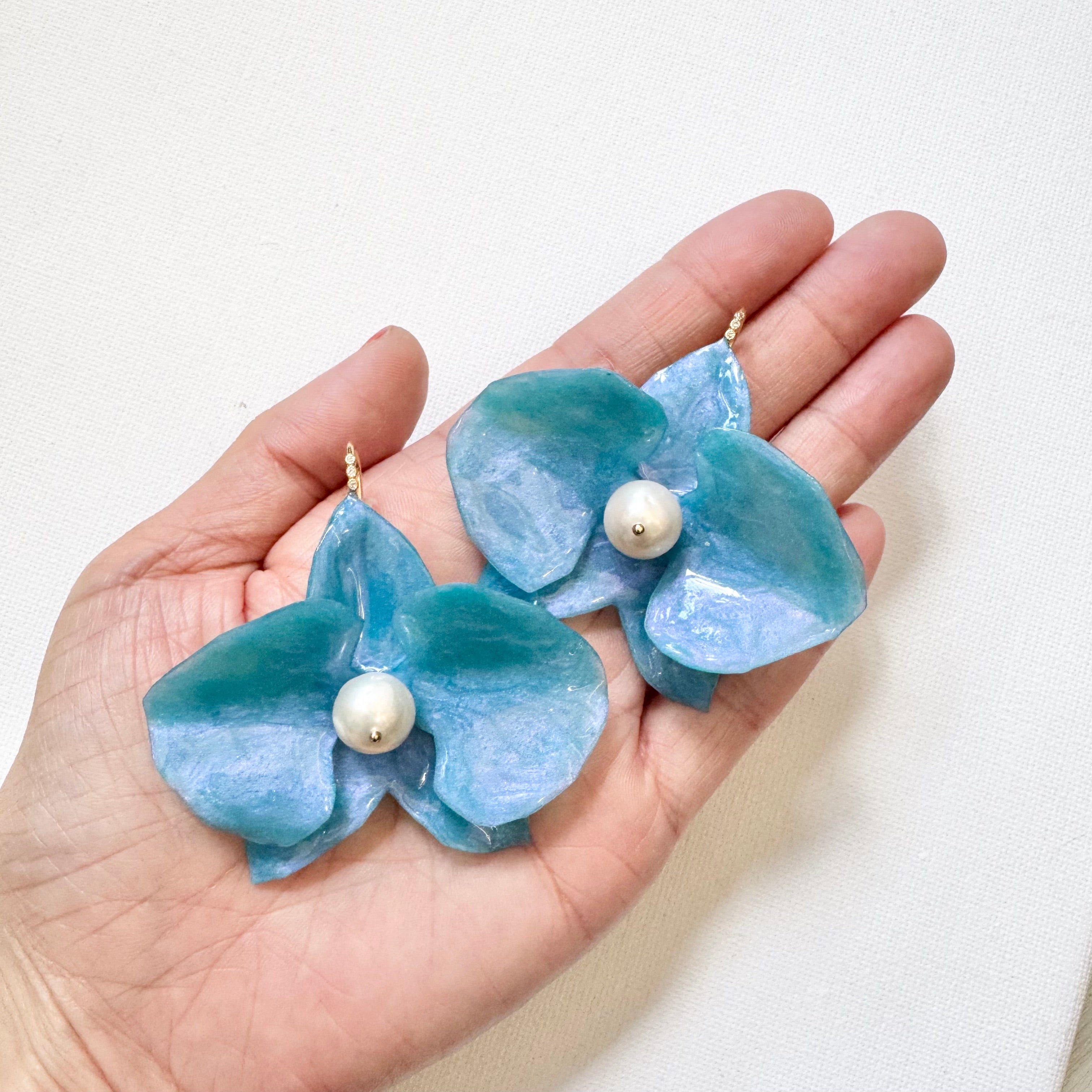 Handmade upcycled orchid earrings crafted from recycled PET bottles, eco-friendly floral jewelry by a Singapore artisan, lightweight and elegant design.