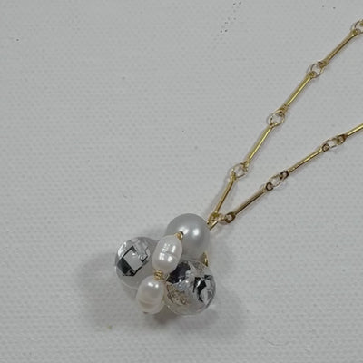 Bee Divine midnight black bee necklace with fresh water pearls handcrafted from upcycled plastic, featuring delicate bee-inspired designs with lightweight, eco-friendly materials. A sustainable statement piece for nature lovers.